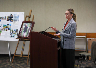 Student stands at podium during her talk on electron microscopy of animal sperm