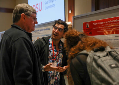 Student explains his biology research poster