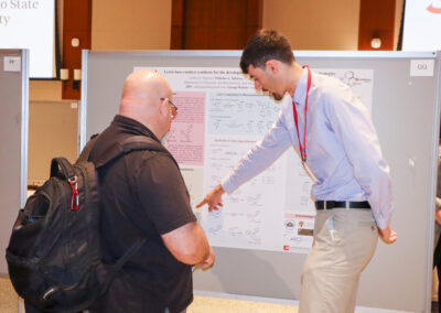 Student explains his cancer research to a professor