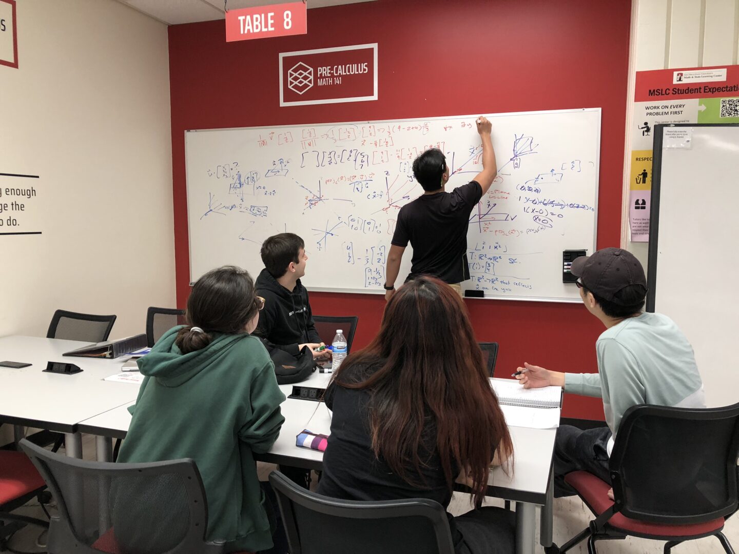 A tutor assists with math problems in the Math and Science Learning Center