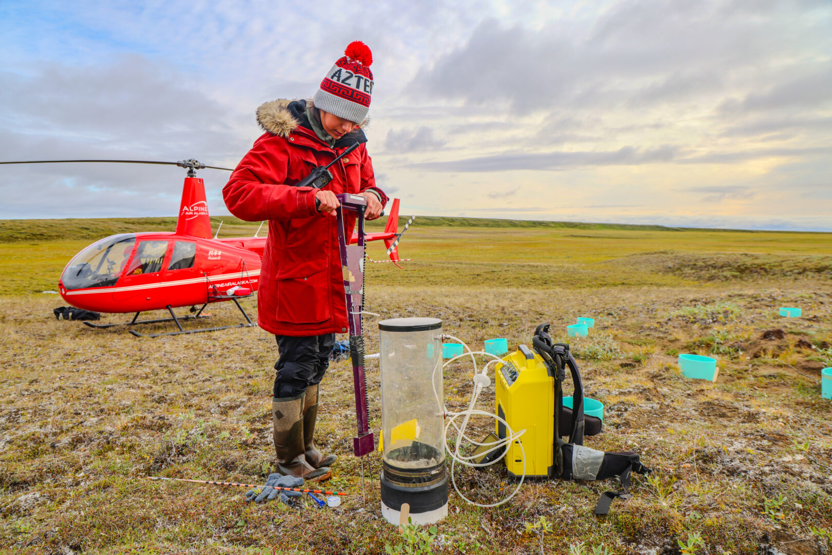 Placing a chamber that flows into a “Ghostbuster” gas analyzer, Tenorio measures differences in nitrous oxide emissions between barren and more vegetated patches of remote, thawed tundra. Back in the labs in Utqiaġvik and San Diego, she and her peers will collaboratively analyze the role that the gases from these permafrost landforms play in the ever-changing Arctic climate.